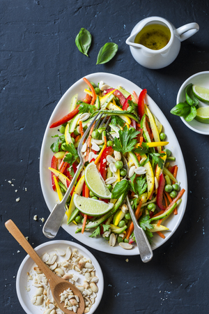 Raw vegetables Pad Thai salad on dark background, top view. Vegetarian healthy foodの写真素材