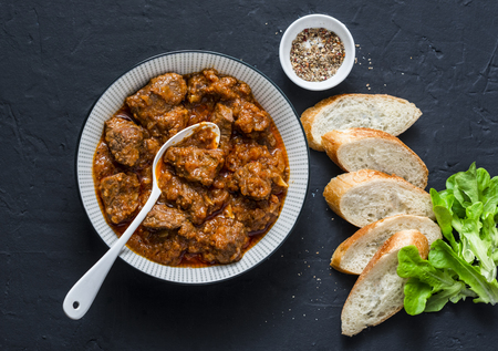 Delicious beef stew. Healthy seasonal comfort food on a dark background, top view. Flat lay, copy spaceの写真素材