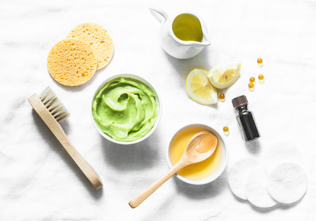 Honey and avocado face mask on light background, top view. Beauty, youth, skin care concept. Flat layの写真素材
