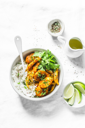 Potatoes and green beans curry sauce with rice and cilantro. Indian vegetarian healthy food on light background, top viewの写真素材