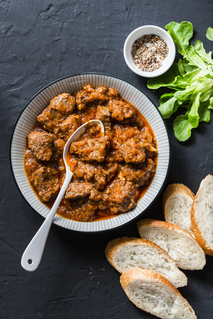 Delicious beef stew. Healthy seasonal comfort food on a dark background, top view. Flat lay, copy spaceの写真素材