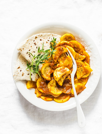 Zucchini curry on a light background, top view. Vegetarian healthy lunchの写真素材