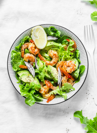 Prawns, avocado, garden herbs salad - delicious healthy snack, appetizers, tapas on a light background, top view. Flat layの写真素材