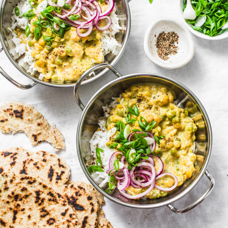 Indian dhal with jasmine rice, marinated red onion, scallion and whole grain flatbread on light background, top view. Flat lay, vegetarian food conceptの写真素材