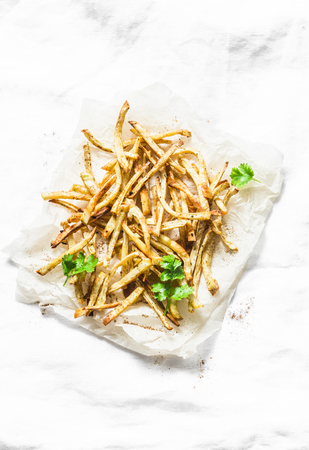Parsnips  fries on light background, top view. Tasty vegetarian snack or appetizerの写真素材