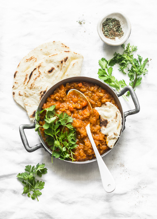Red lentils dhal and paratha flatbread - healthy vegetarian dinner in Indian style on light background, top viewの写真素材