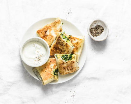 Fried stuffed chickpeas, spinach, leek and mozzarella rolls on a light background, top view. Delicious snack, appetizers, tapas or breakfastの写真素材