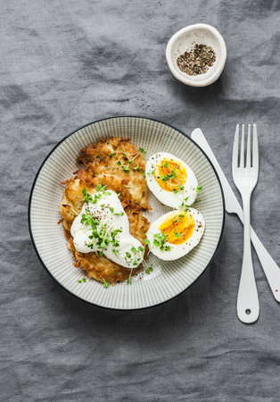 Potato latkes and boiled egg - healthy breakfast or snack on grey background, top viewの写真素材