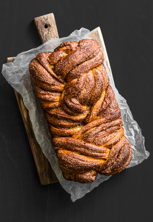 Easy cinnamon and brown sugar brioche on a dark background, top viewの写真素材