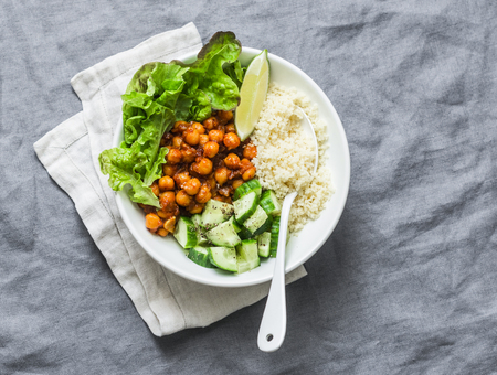 Detox moroccan spiced chickpea glow bowl on a grey background, top view. Vegetarian food conceptの写真素材
