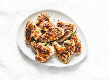 French mustard marinade roasted chicken wings - delicious appetizers, tapas on light background, top viewの写真素材