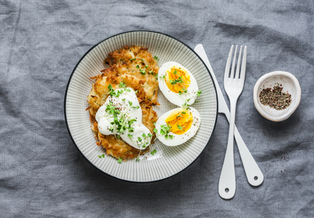 Potato latkes and boiled egg - healthy breakfast or snack on grey background, top viewの写真素材