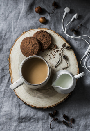 Coffee break - coffee and chocolate cookies on grey background, top view. Cozy home still lifeの写真素材