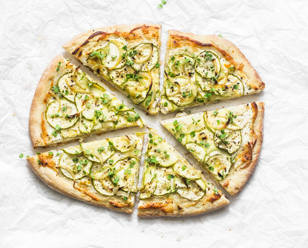 Vegan macadamia ricotta and squash pizza on light background, top view