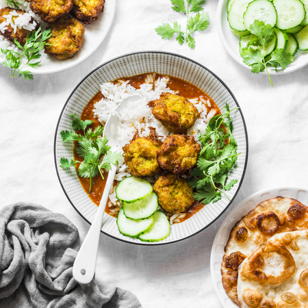 Pumpkin squash kofta with rice and curry sauce. Healthy vegetarian food on light background, top viewの写真素材
