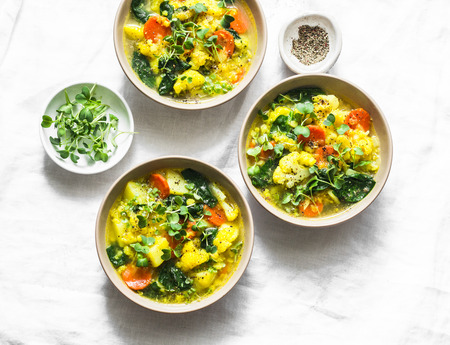Yellow lentils and vegetables thick vegetarian soup on a light background, top view. Healthy food conceptの写真素材