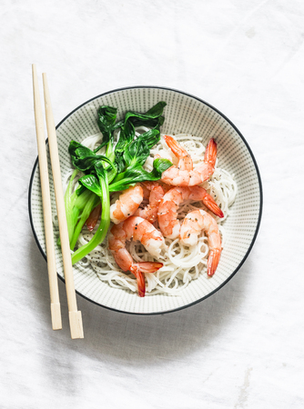 Rice noodles with shrimp and bok choy cabbage on a light background, top viewの写真素材