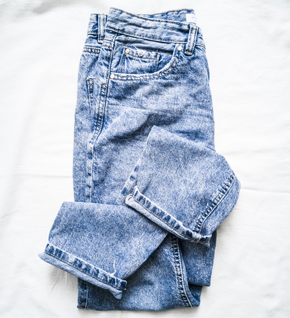 Blue faded mom jeans on a light background, top view. Fashion clothing conceptの写真素材