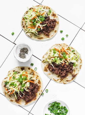 Spicy beef and coleslaw tacos on light background, top viewの写真素材
