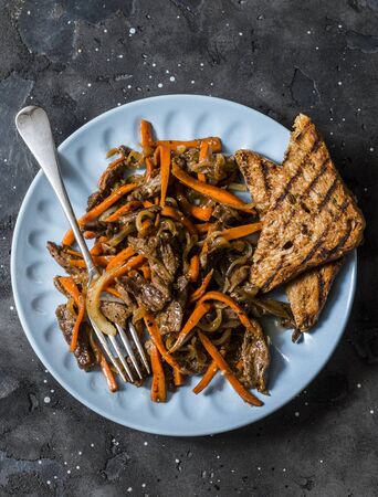 Spicy fried beef wok with carrots on a dark background, top viewの写真素材