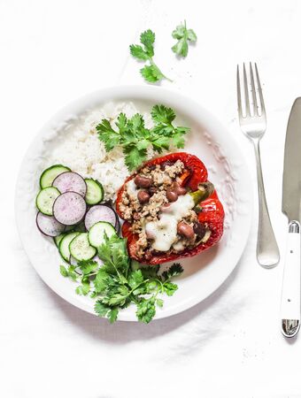 Balanced lunch - rice, stuffed chili beans beef sweet pepper, vegetables on a light background, top viewの写真素材