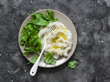 Cauliflower mashed with spinach. Delicious vegetarian lunch or garnish on a dark background, top viewの写真素材