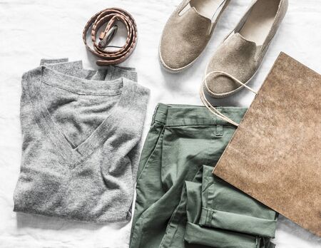 Set of women's fashion clothes - pullover, cotton pants, suede sports shoes, leather belt and paper...