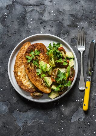 Savory french toast with avocado, cherry tomatoes salad on dark background, top viewの写真素材