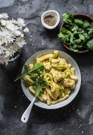 Curried creamy salmon with pasta on a dark background, top viewの写真素材