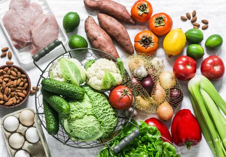 Home menu planning concept - fresh fruits, vegetables, eggs, nuts, meat on a light background, top view. Healthy diet foodの写真素材