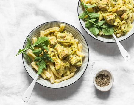 Curried creamy salmon with pasta on a light background, top viewの写真素材