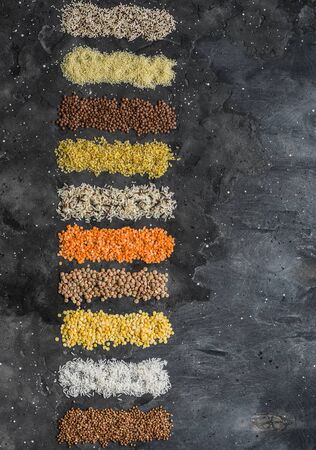 Variety of cereals, grains. Bulgur, rice, quinoa, lentils, couscous, buckwheat on a dark background, top view. Protein food conceptの写真素材