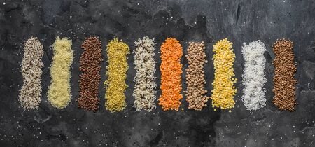 Variety of cereals, grains. Bulgur, rice, quinoa, lentils, couscous, buckwheat on a dark background, top view. Protein food conceptの写真素材