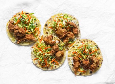Korean tempura fried shrimp and coleslaw tacos on light background, top viewの写真素材