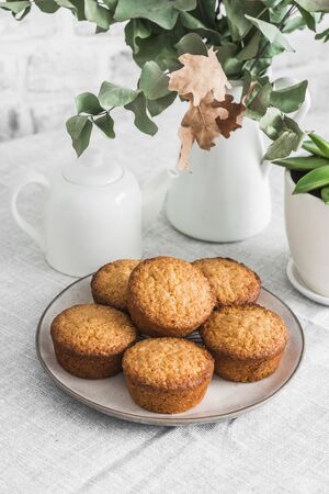 Simple almond muffins on the table. Cozy kitchen still life, dessert tableの写真素材