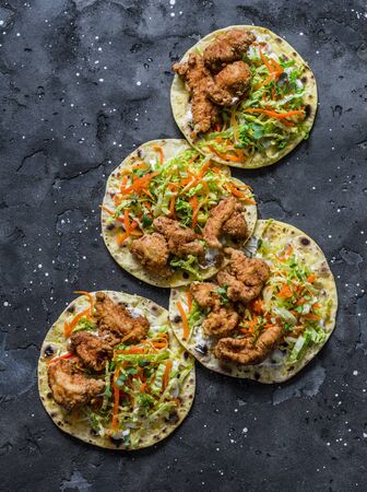 Korean tempura fried shrimp and coleslaw tacos on dark background, top viewの写真素材