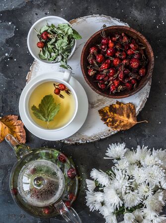 Green tea with rose hips - increase immunity in autumn and winter on a dark background, top viewの写真素材