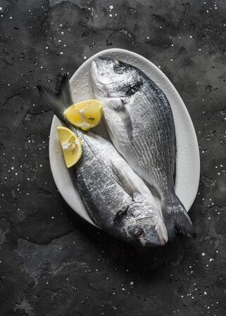 Fresh raw  dorado on dark background, top view. Food ingredientsの写真素材