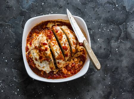 Turkey tomato sauce mozzarella cheese meatloaf in a baking dish on a dark background, top viewの写真素材