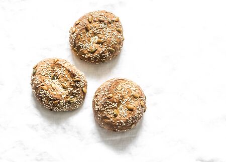 Multigrain multiseed fitness buns on light background, top view. Copy spaceの写真素材