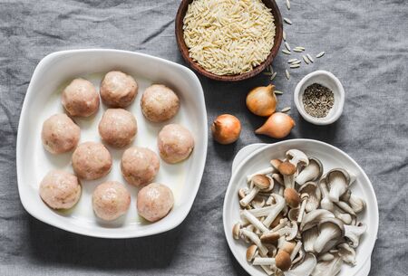 Ingredients for making orzo mushrooms pasta with teriyaki sauce chicken baked meatballs on a gray background, top viewの写真素材
