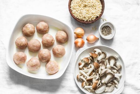 Ingredients for cooking orzo mushrooms pasta with teriyaki sauce chicken roasted meatballs on a light background, top viewの写真素材