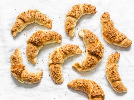 Homemade puff pastry croissants with walnut and brown sugar filling on a light background, top viewの写真素材