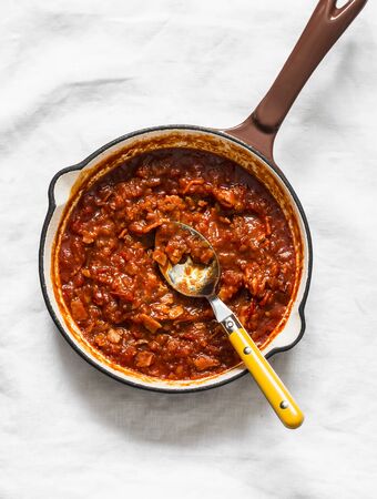 Classic homemade amatriciana tomato sauce in the cooking pan on a light background, top view. Pasta bucatini amatriciana tomato sauceの写真素材