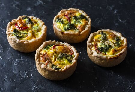 Broccoli, ham, cheddar pies on dark background, top view. Delicious appetizers, snack, tapasの写真素材