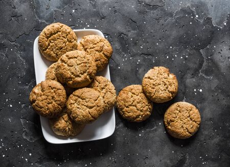 Delicious oatmeal cookies with walnuts on a dark background, top viewの写真素材
