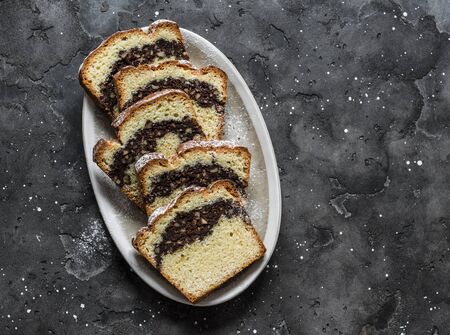 Homemade buttery cake with chocolate nut streusel on a dark background, top view. Copy spaceの写真素材