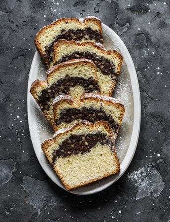Homemade buttery cake with chocolate nut streusel on a dark background, top view. Copy spaceの写真素材