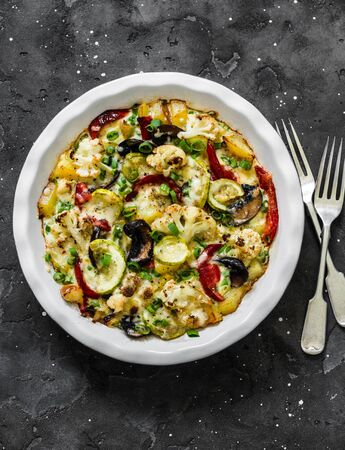Baked vegetables frittata - delicious appetizer, tapas, snack, breakfast on a dark background, top viewの写真素材