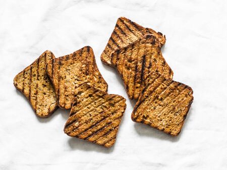 Whole grain seeds grilled toast bread for sandwiches on a light background, top viewの写真素材